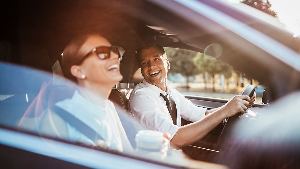 Man driving with woman passenger