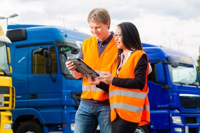 Fleet managers in front of trucks