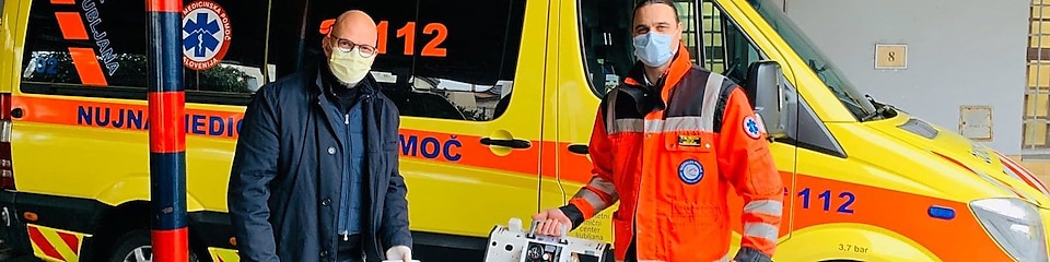 Two members of medical staff holding respirators in hand